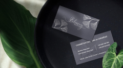 Clean minimal business card mockup on black stone plate with leaf background. PSD file.